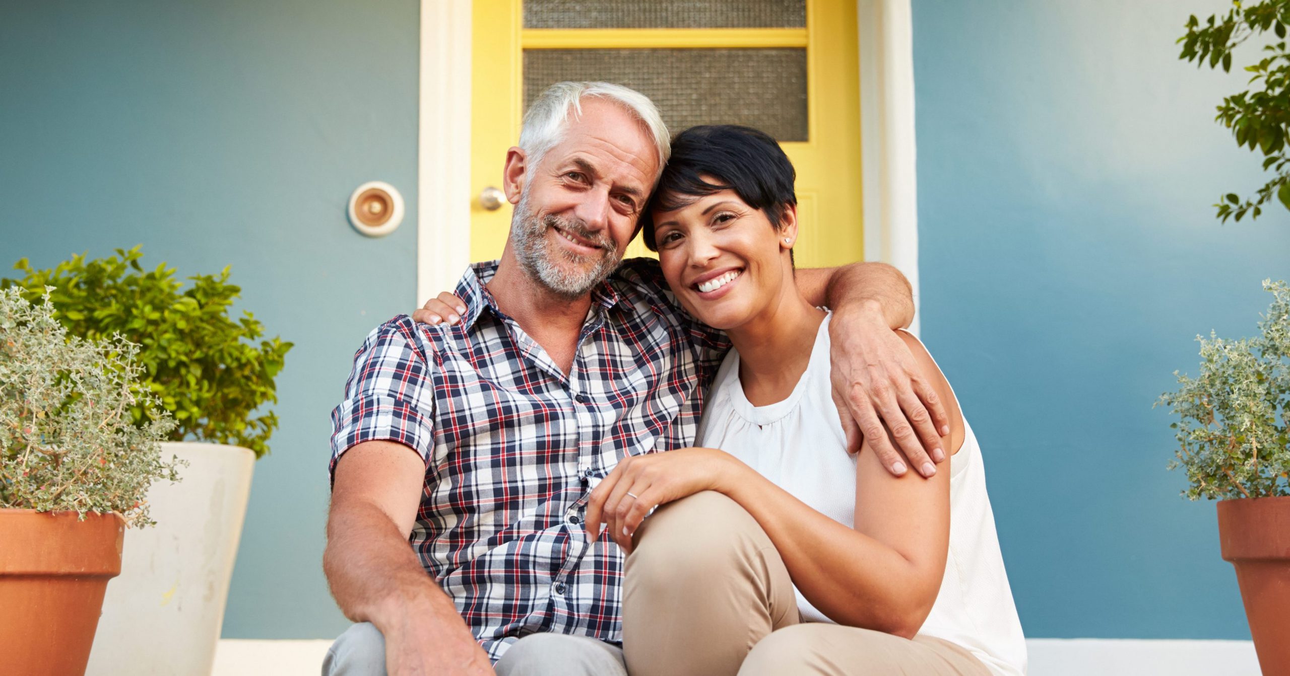 man and woman smiling on their front porch, urology compounding
