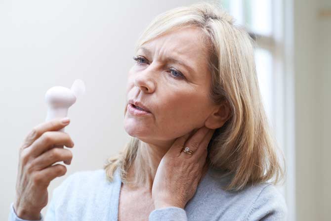 woman experiencing hot flashes menopause