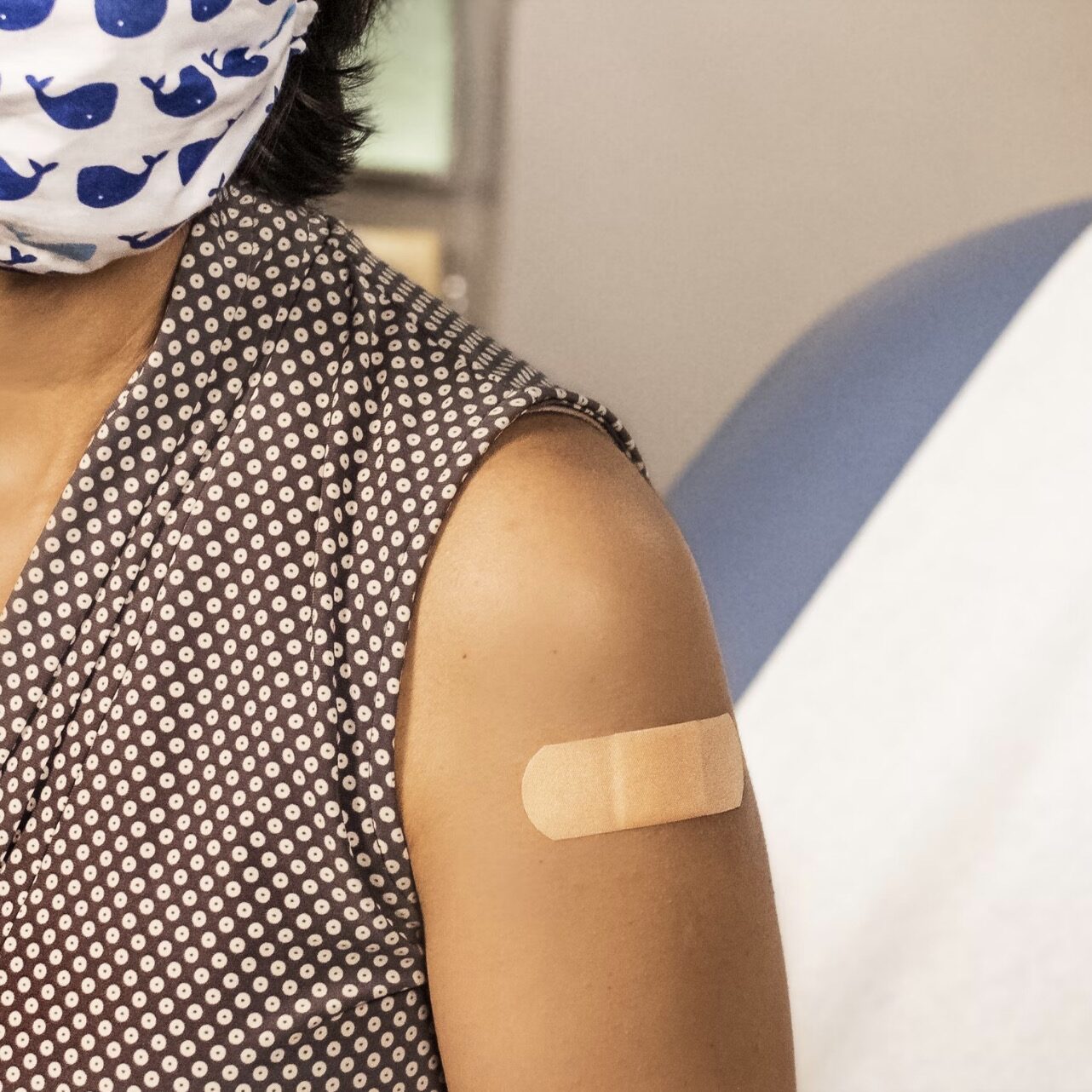 Woman with bandaid on her arm just received an immunization at Clark compounding pharmacy in Ann Arbor Michigan